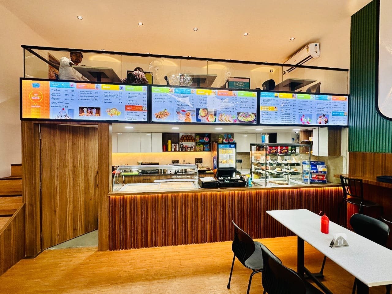 Mother Dairy Café, Sector 11 Noida — service counter and menu boards